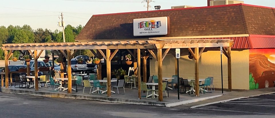 Mexican restaurant dining room with simple tables and chairs.